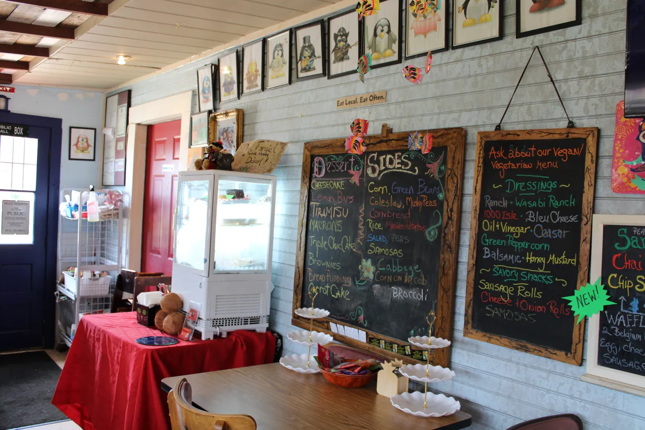 Hand-written chalkboard menus and shelves of homemade preserves inside Pengus's Place